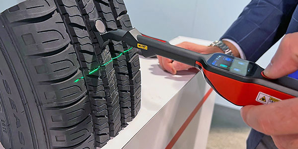 Professional tyre inspection tool measuring tread depth with laser precision